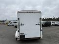 A white 2016 Continental cargo trailer viewed from the rear with two doors and a smooth surface showcasing the manufacturer's logo