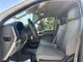 2019 Ford F-550 interior with gray fabric seats and dashboard visible from the driver's side featuring steering wheel and controls