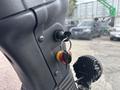 A close-up of the ignition switch and key on a 2019 Madvac LS175 with a red and yellow button next to it