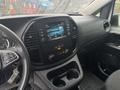 Interior view of a 2021 Mercedes-Benz Metris featuring a central infotainment system dashboard air conditioning controls and cup holders