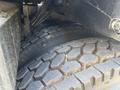 A close-up view of two heavy-duty tires from a 2012 International DuraStar 4300 showcasing the tread pattern and rubber texture
