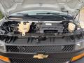 A 2021 Chevrolet Express with the hood open revealing the engine compartment showcasing various engine components and hoses