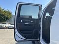 A white 2018 RAM 3500 pickup truck with its driver-side door open showing interior features and black upholstery