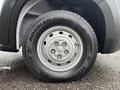 A close-up view of a tire from a 2023 RAM Promaster 3500 featuring a silver wheel rim and a black tire with the label ROADIAN visible on the sidewall