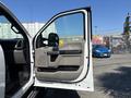 A 2019 Ford F-550 with the driver's door open revealing the interior features and seating arrangement
