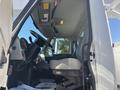 Interior view of a 2013 International 7500 truck featuring the driver's seat steering wheel and dashboard with control buttons and gauges