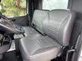 Interior view of a 2025 Peterbilt 536 showing two gray leather seats designed for comfortable driving and passenger support