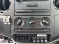 The dashboard controls of a 2010 Ford F-550 Super Duty featuring knobs for temperature and air conditioning with labeled auxiliary switches