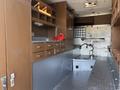 Interior of a 2008 International 4400 with wooden cabinets drawers and shelves organized for storage and functionality