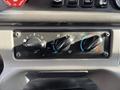 A control panel with three knobs for adjusting air flow and temperature in a 2013 Freightliner 114SD vehicle