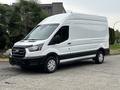 A white 2020 Ford Transit 250 van with a high roof and cargo area, featuring a black stripe at the bottom and alloy wheels