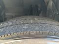 Close-up of a worn tire on a 2022 Isuzu NRR showing tread wear and sidewall details