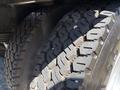 Close-up of two large truck tires from a 2011 International 4300 showing deep treads and detailed rubber pattern