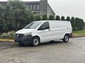 A 2021 Mercedes-Benz Metris van in white with a cargo area and black front grille parked on a road