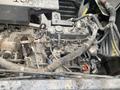 A 2010 Kubota RTV 900 engine compartment with various components including hoses wires and mechanical parts visible