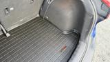 The trunk space of a 2019 Nissan Kicks featuring a black rubber mat and side storage compartments