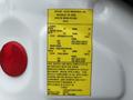 A yellow label attached to a white surface displaying specifications for a 2013 Freightliner 114SD including weight ratings and manufacturing details
