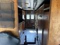Interior of a 2008 Workhorse W62 showing wooden cabinets and storage along one side with a driver's seat visible in the foreground