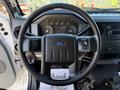 Steering wheel of a 2017 Ford F-650 Super Duty with controls and dashboard gauges visible in the background