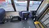 Interior view of a 2021 Ford Transit showing driver's seat controls and safety features with a focus on the driver's area