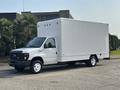 A white 2008 Ford Econoline van with a tall box-like cargo area and a single rear axle parked on a paved surface