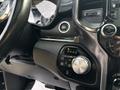 Close-up of the gear shift area in a 2021 RAM 1500 showing the P R N D dial and buttons for drive modes and settings