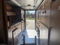 Interior view of a 2008 Workhorse W62 with wooden cabinets and counters visible throughout the space