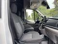 Interior of a 2020 Ford Transit 250 featuring two gray fabric front seats with adjustable headrests and a dashboard with a central touchscreen display
