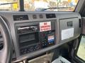 Interior dashboard of a 2020 Peterbilt 330 featuring a radio, climate controls, and a warning sign stating no smoking in vehicle