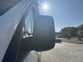 A side view mirror of a 2017 Ford Transit-350 reflecting sunlight