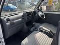 Interior view of a 2010 Daihatsu Hijet showing the dashboard seats and gear shift with a gray color scheme