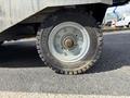 A close-up view of a tire mounted on a 2023 Bitimec SC415 showcasing a rugged tread design and a metal rim