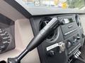 Close-up of the gear selector and control panel of a 2010 Ford F-550 Super Duty showing gauges and knobs for vehicle settings and towing functions