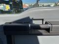 A close-up view of the door handle on a 2011 Ford F-550 featuring a textured grip and a sleek design