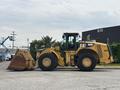 A yellow 2012 Caterpillar 980K wheel loader with a large bucket in front, featuring oversized tires and a visible cabin for operation