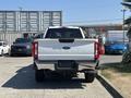 A white 2023 Ford F-350 SD truck viewed from the rear showing the Super Duty badge on the tailgate and a chrome bumper