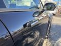 A 2023 Fisker Ocean with a sleek black exterior showcasing a side profile view and door handle