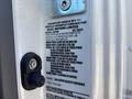 A metal plate from a 2022 Isuzu NRR displaying vehicle specifications including weights and pressure requirements
