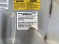 Label attached to a 2016 Isuzu NPR-HD detailing spark ignition systems information and compliance with Canadian ICES-002 regulations