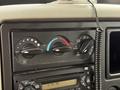 Dashboard controls of a 2012 International TerraStar featuring knobs for temperature and fan settings along with a digital clock display