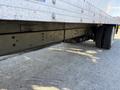Close-up of the underside of a 2012 Freightliner M2 106 showing the axles and tires along with the trailer's structural components