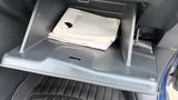 A 2019 Nissan Kicks glove compartment containing papers and a manual