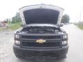 A 2015 Chevrolet Silverado 1500 with its hood open showcasing the engine compartment and front grille with the Chevrolet emblem
