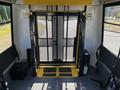 Interior view of a 2017 Ford Transit-350 featuring a wheelchair lift with a yellow platform and black mesh safety guard