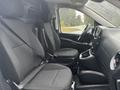 Interior view of a 2021 Mercedes-Benz Metris showing two black fabric front seats and the dashboard with controls and a steering wheel