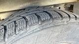 Close-up of a tire from a 2021 Ford Transit showcasing detailed tread patterns and grooves