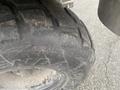 Close-up of a rugged tire on a 2010 Kubota RTV 900 showcasing deep treads and the manufacturer label on the sidewall
