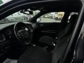 Interior view of a 2017 Dodge Charger featuring black cloth seats a steering wheel with controls and a dashboard with display screens