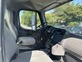 Interior of a 2014 Freightliner M2 106 truck featuring a driver's seat steering wheel and dashboard