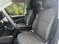 The interior of a 2021 Mercedes-Benz Metris features two black fabric seats with headrests and a steering wheel visible in the foreground